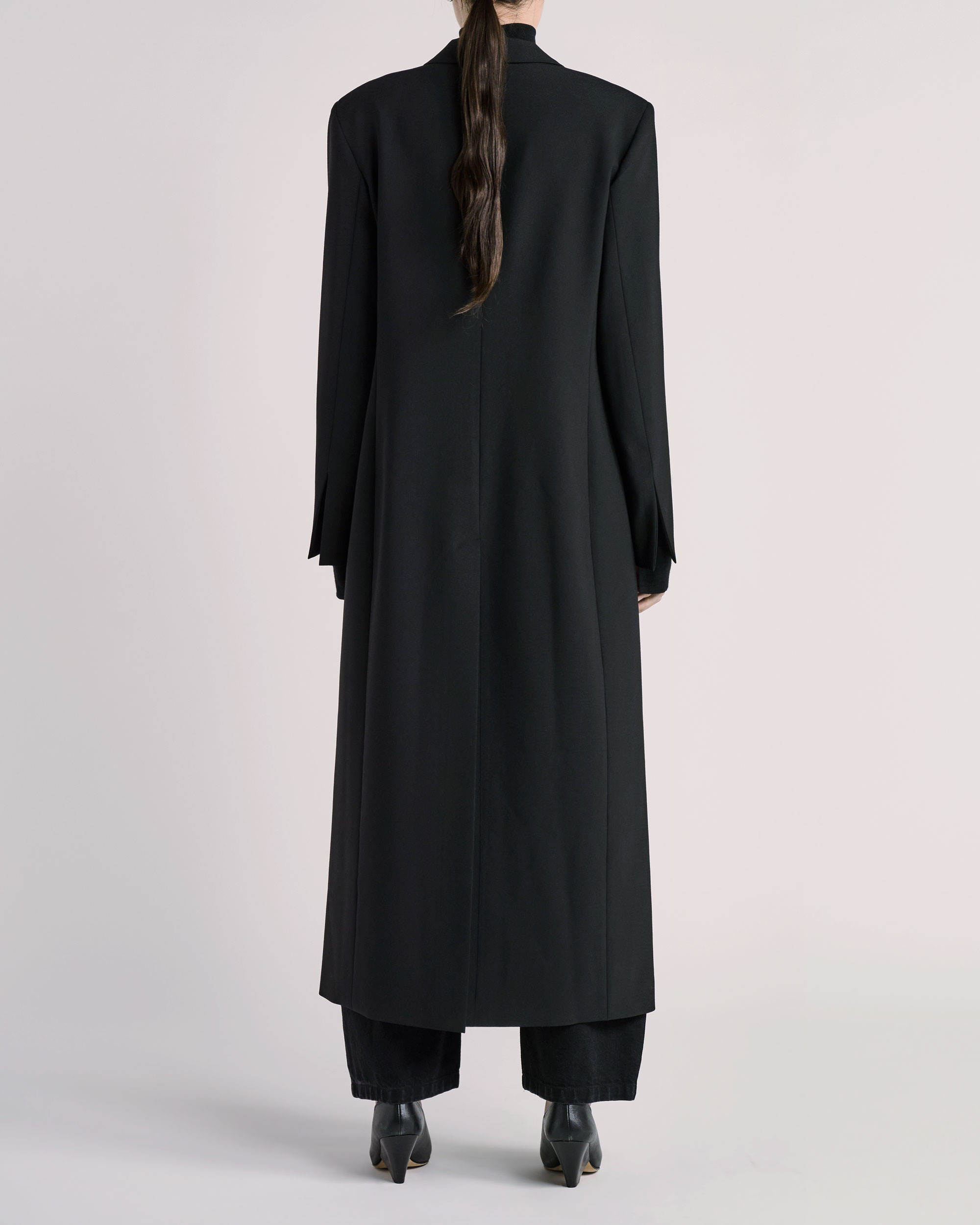 Back view of ESSE coat photographed for fashion e-commerce