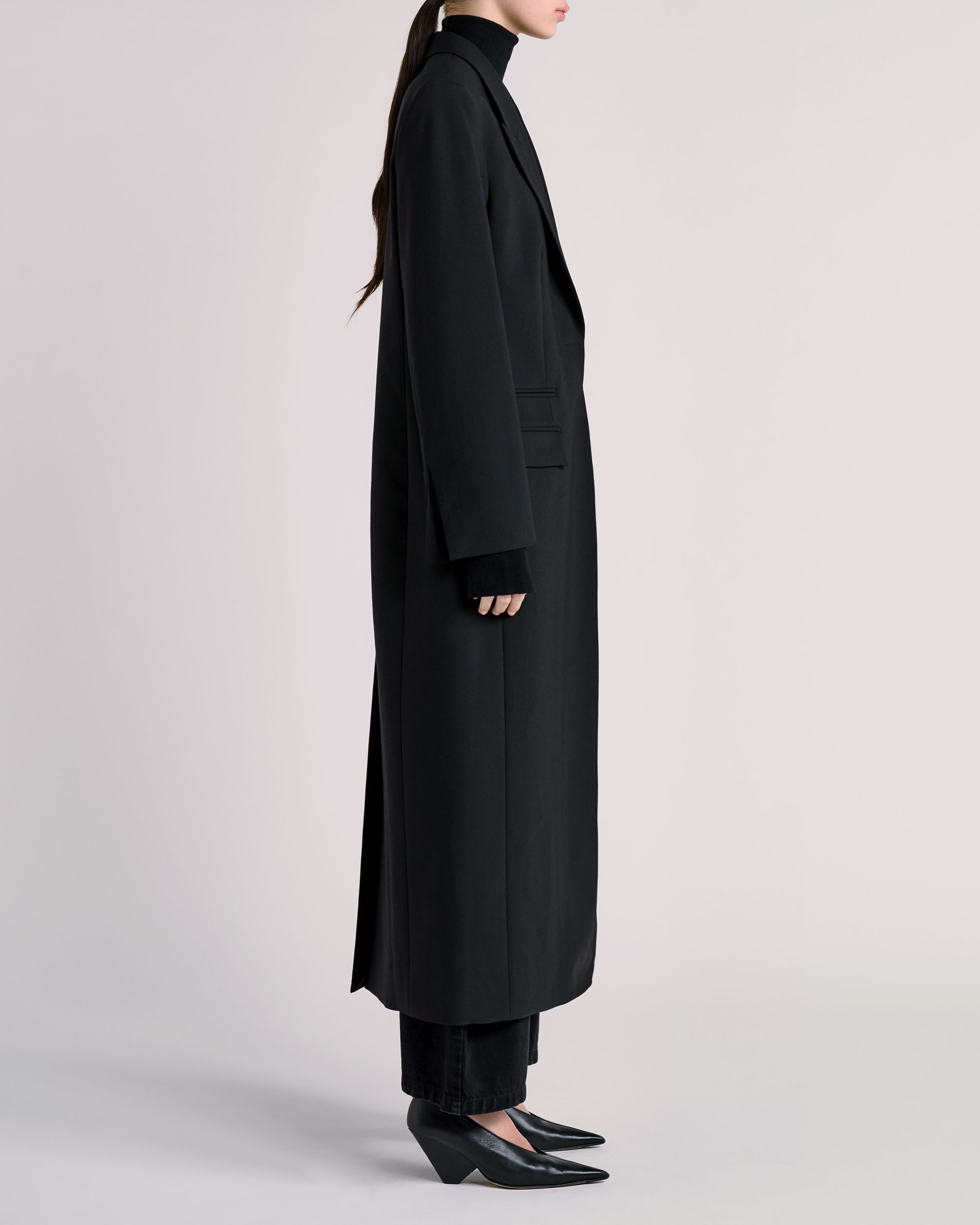 Side view of ESSE coat photographed for fashion e-commerce
