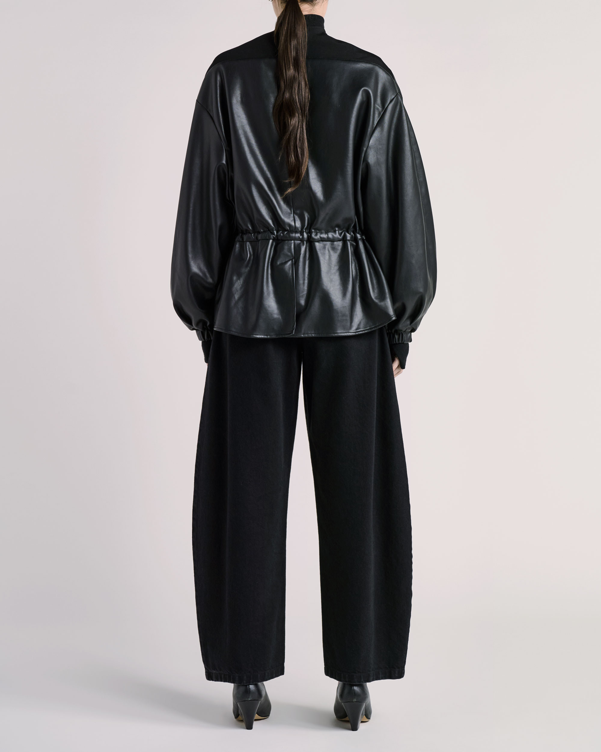 Back view of ESSE jacket photographed for fashion e-commerce