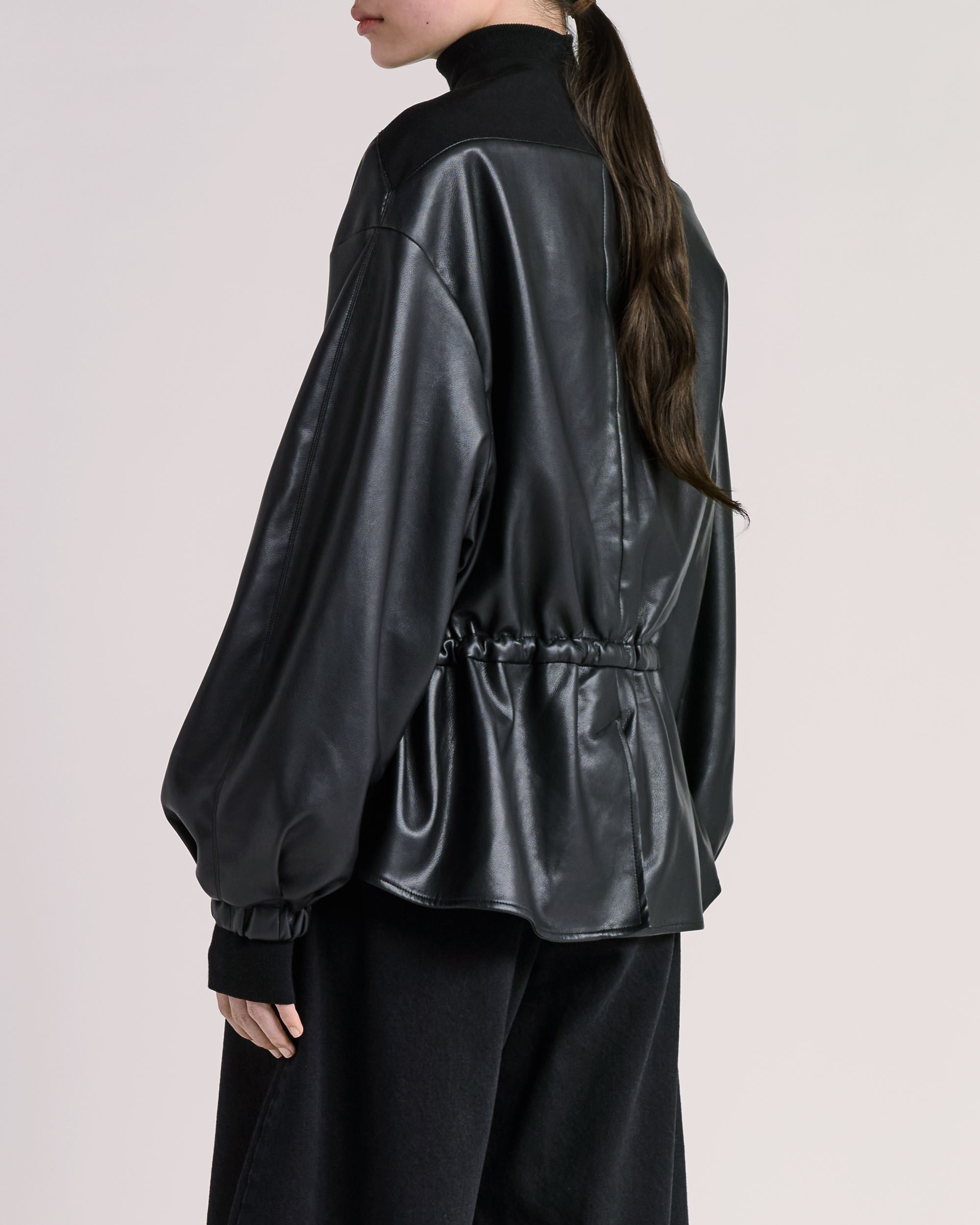 Back 3-4 detail view of ESSE jacket photographed for fashion e-commerce
