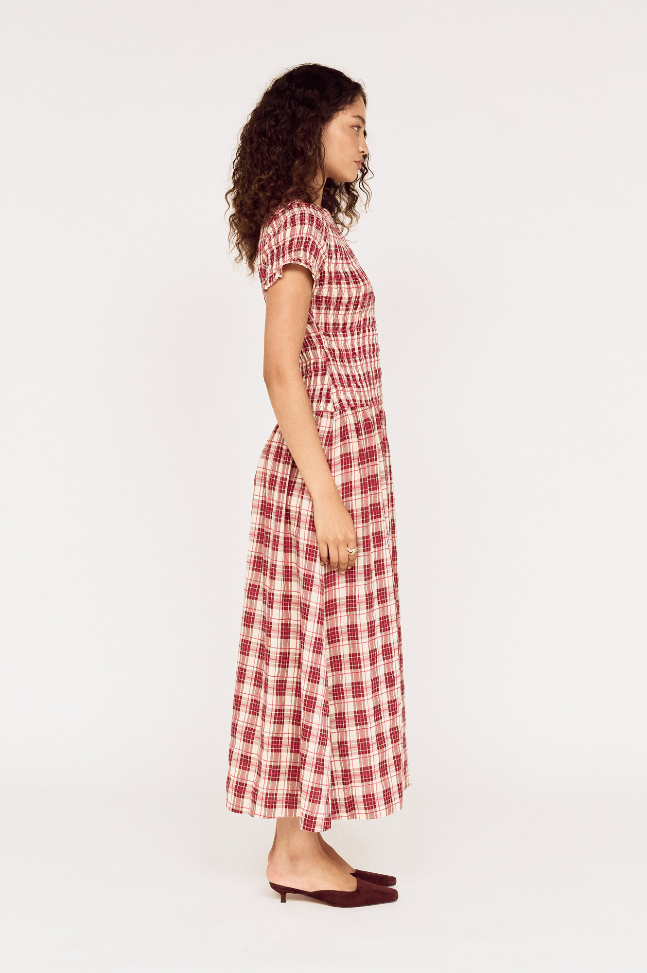 Side view of a model wearing a MINKPINK red check midi dress photographed for fashion e-commerce by Shoot.Studio in Sydney.
