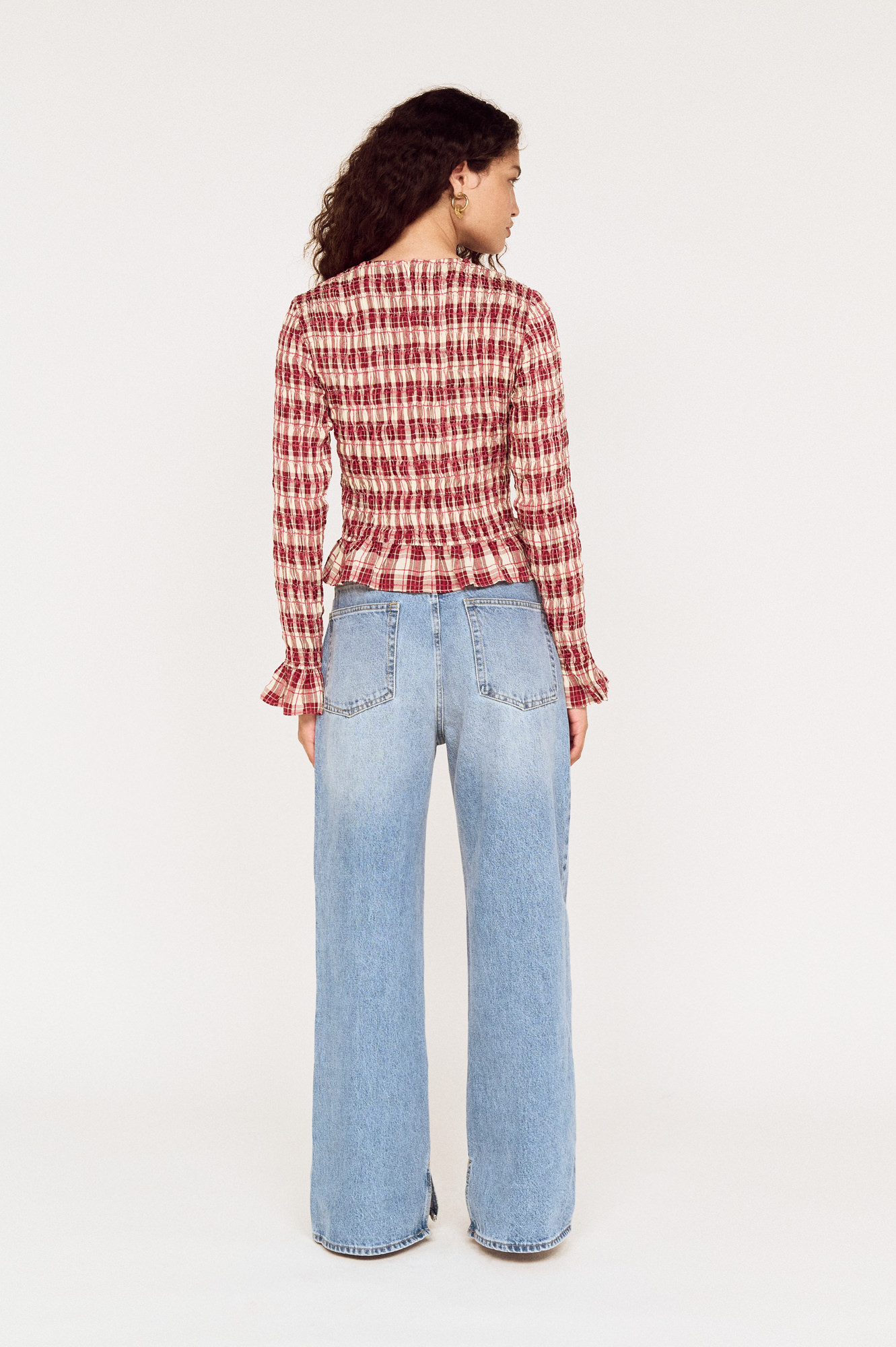 Back view of a model wearing a MINKPINK red check top with wide-leg jeans photographed for fashion e-commerce by Shoot.Studio in Sydney.