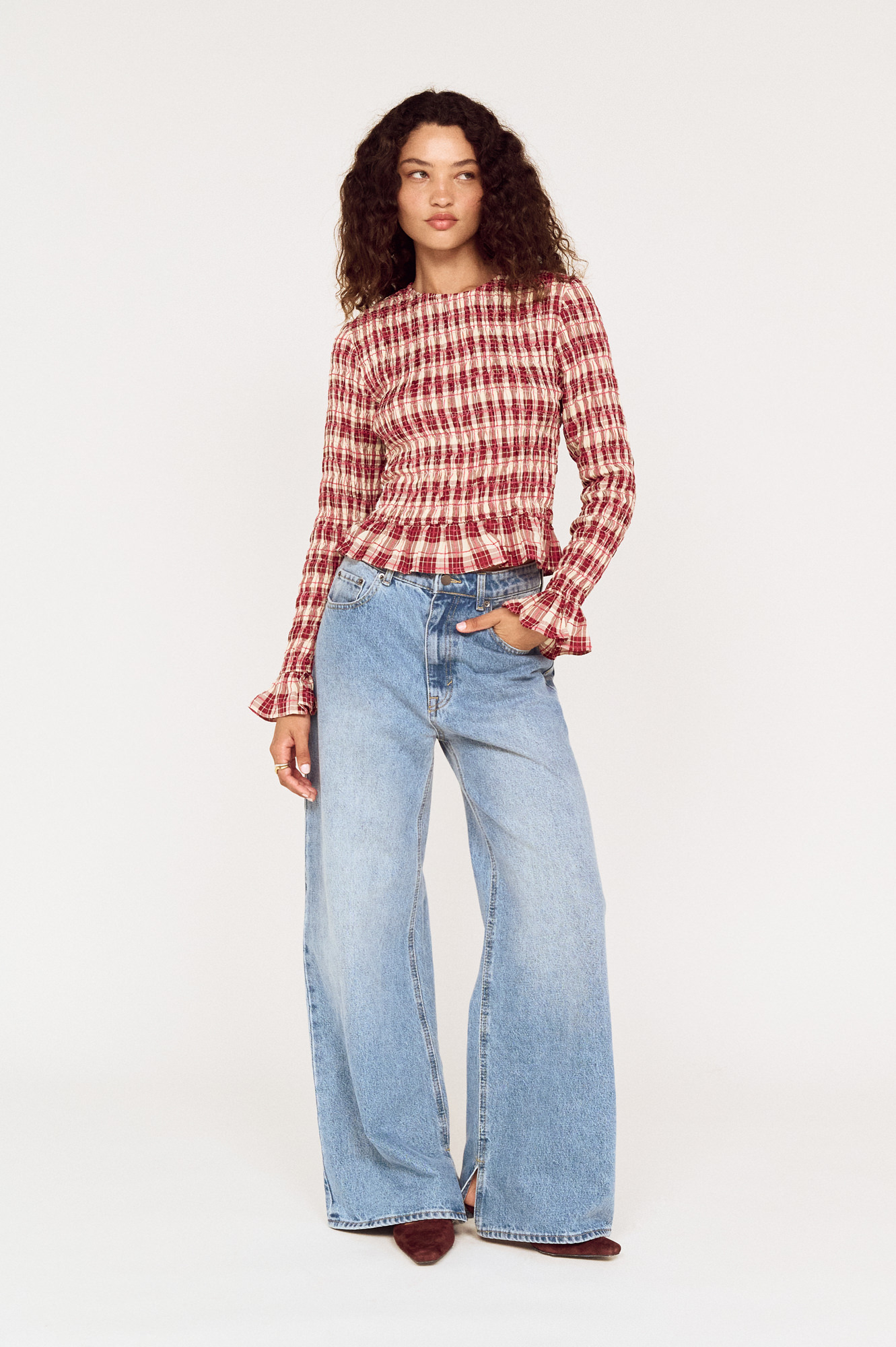 Front view of a model wearing a MINKPINK red check top with wide-leg jeans photographed for fashion e-commerce by Shoot.Studio in Sydney.
