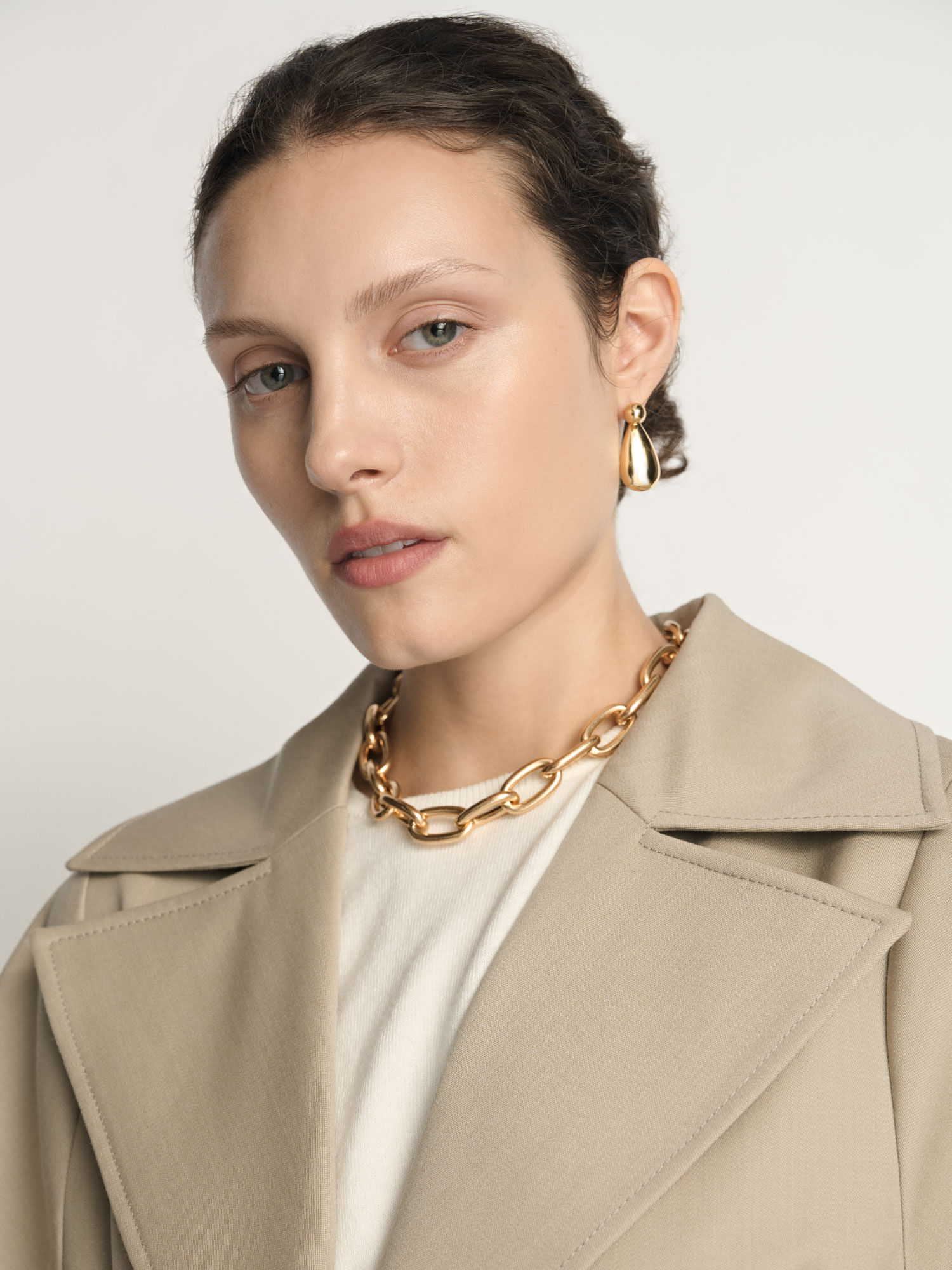 Beauty portrait of a model wearing a Veronika Maine trench coat photographed for fashion e-commerce.