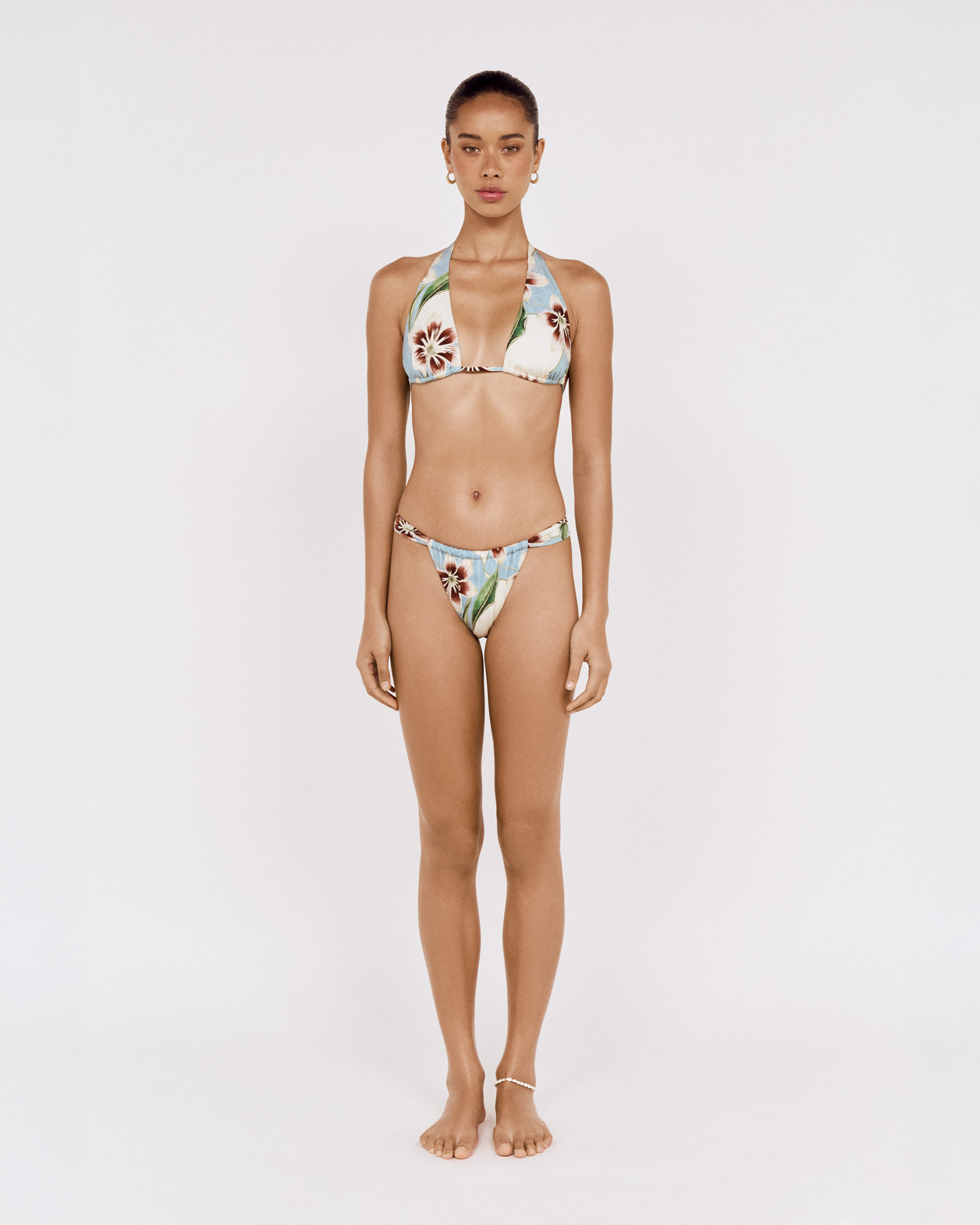 Full-length front view of a model wearing a MINKPINK floral bikini, photographed for fashion e-commerce by Shoot.Studio in Sydney.