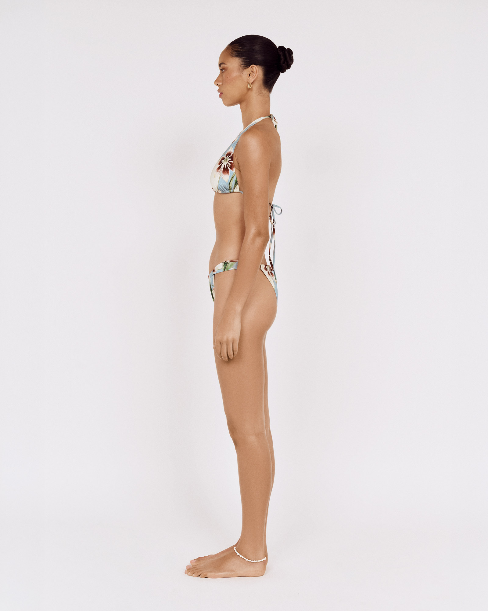 Side view of a model wearing a MINKPINK floral bikini, photographed for fashion e-commerce by Shoot.Studio in Sydney.