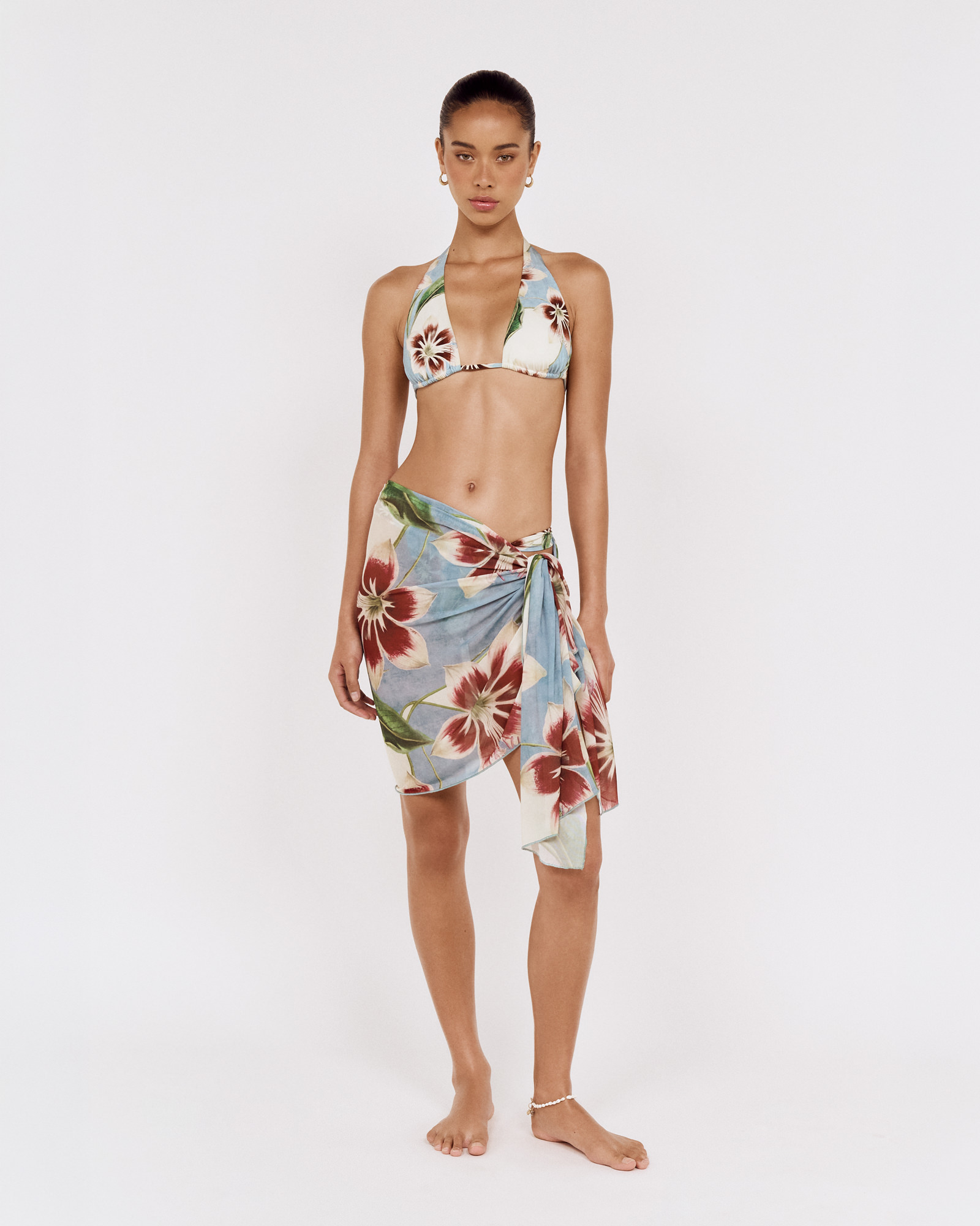 Front view of a model wearing a MINKPINK floral bikini with a matching sarong, photographed for fashion e-commerce by Shoot.Studio in Sydney.