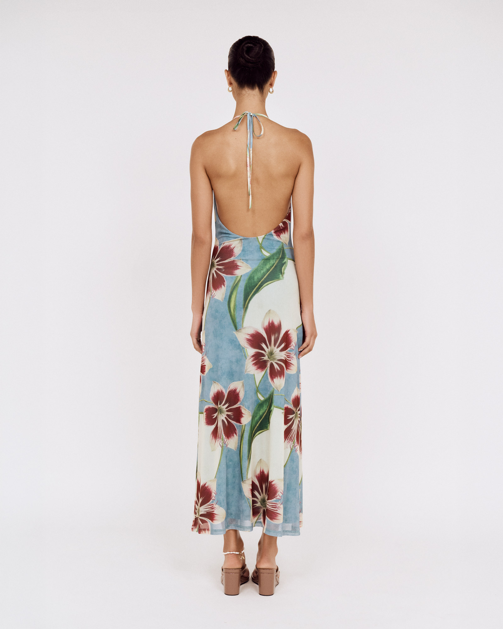 Back view of a model wearing a MINKPINK floral halter maxi dress, photographed for fashion e-commerce by Shoot.Studio in Sydney.
