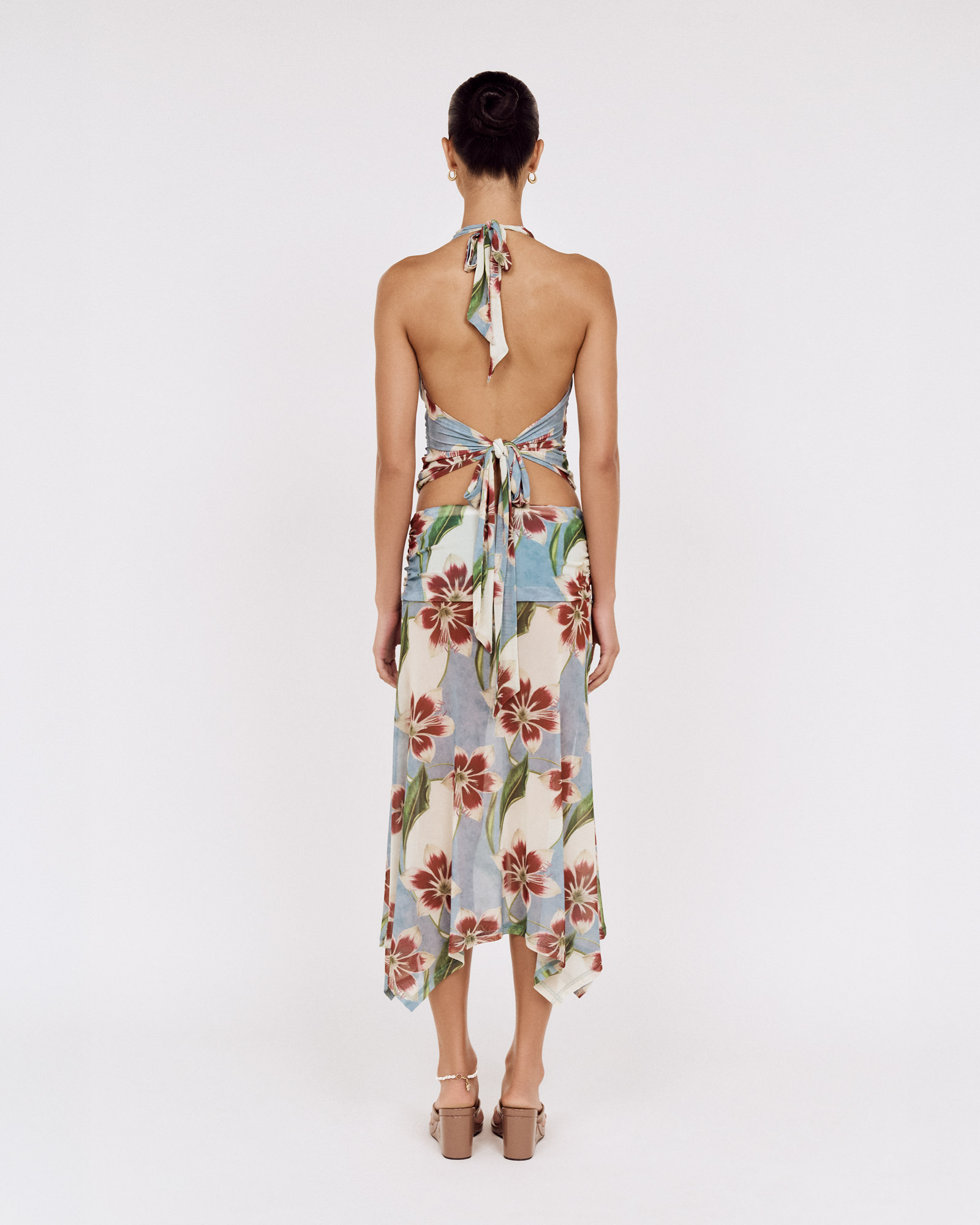 Back view of a model wearing a MINKPINK floral halter top and matching skirt, photographed for fashion e-commerce by Shoot.Studio in Sydney.