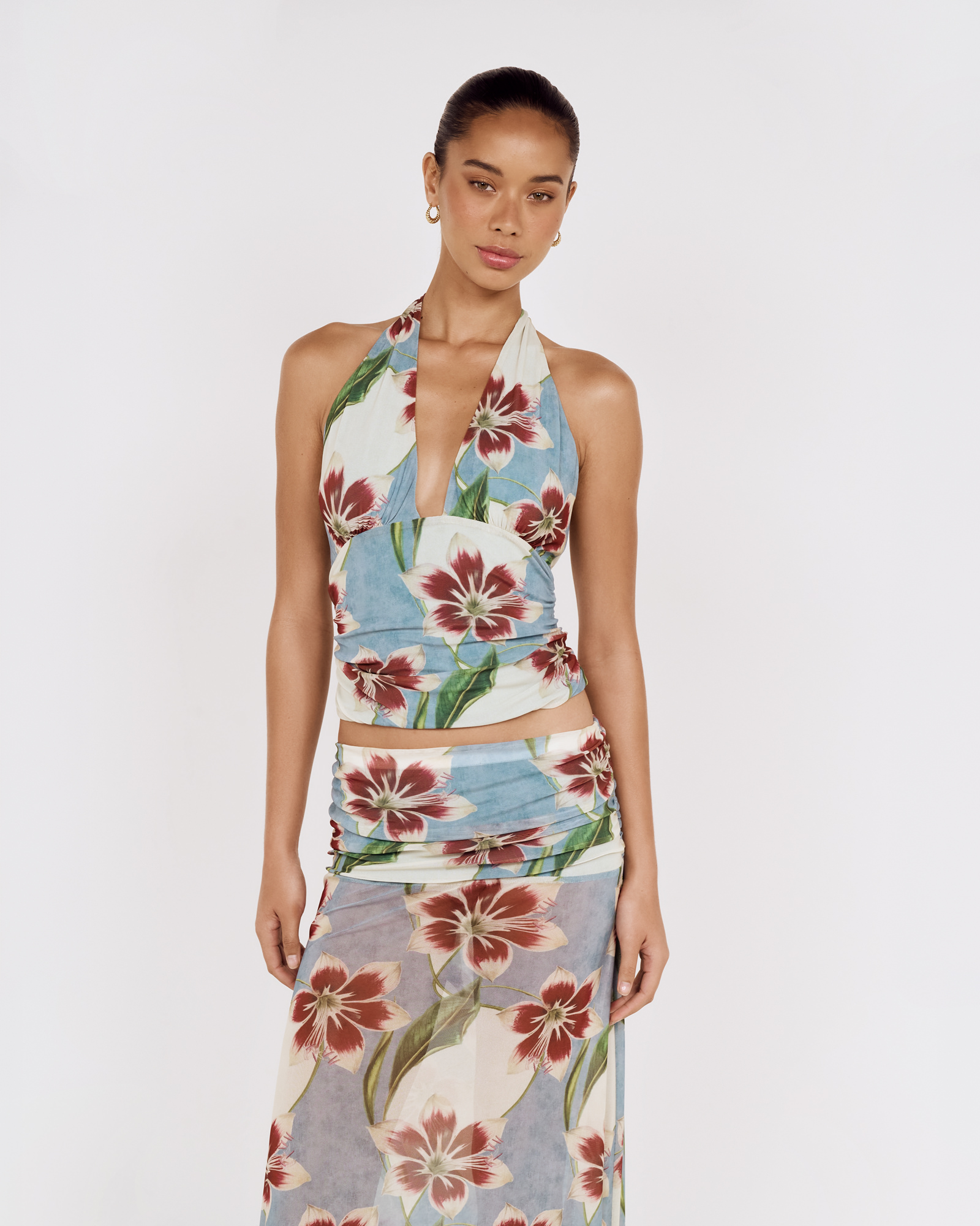 Detail view of a model wearing a MINKPINK floral halter top and matching skirt, photographed for fashion e-commerce by Shoot.Studio in Sydney.