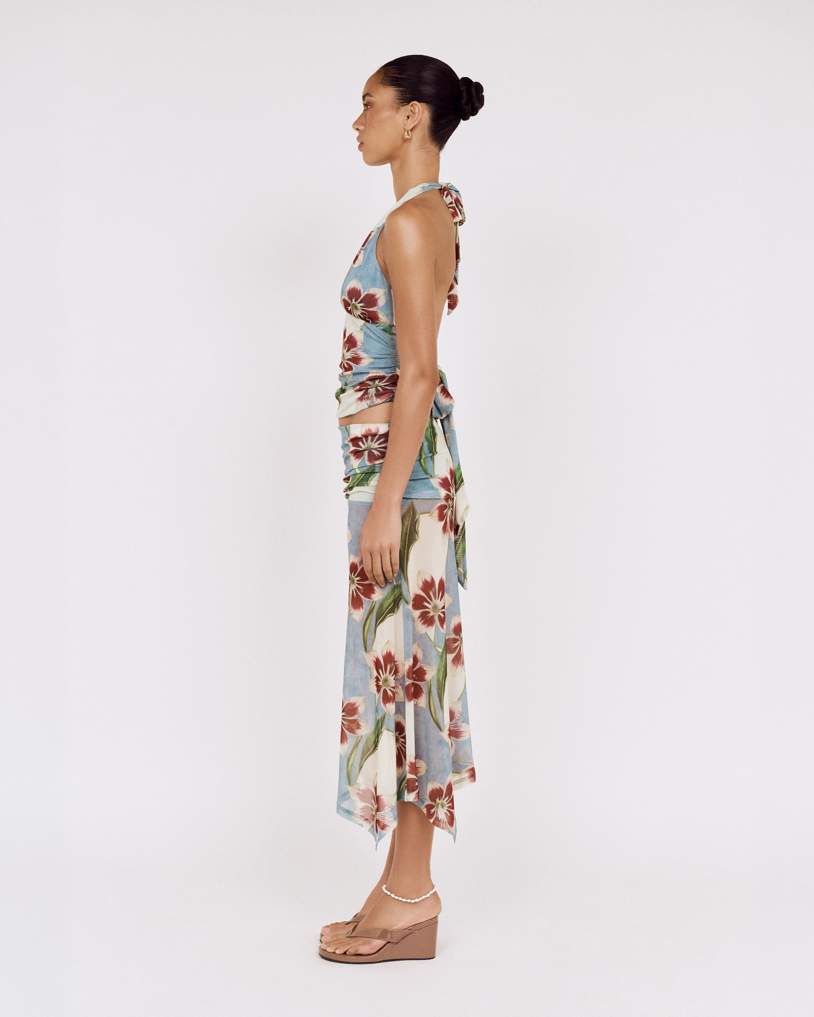 Side view of a model wearing a MINKPINK floral halter top and matching skirt, photographed for fashion e-commerce by Shoot.Studio in Sydney.