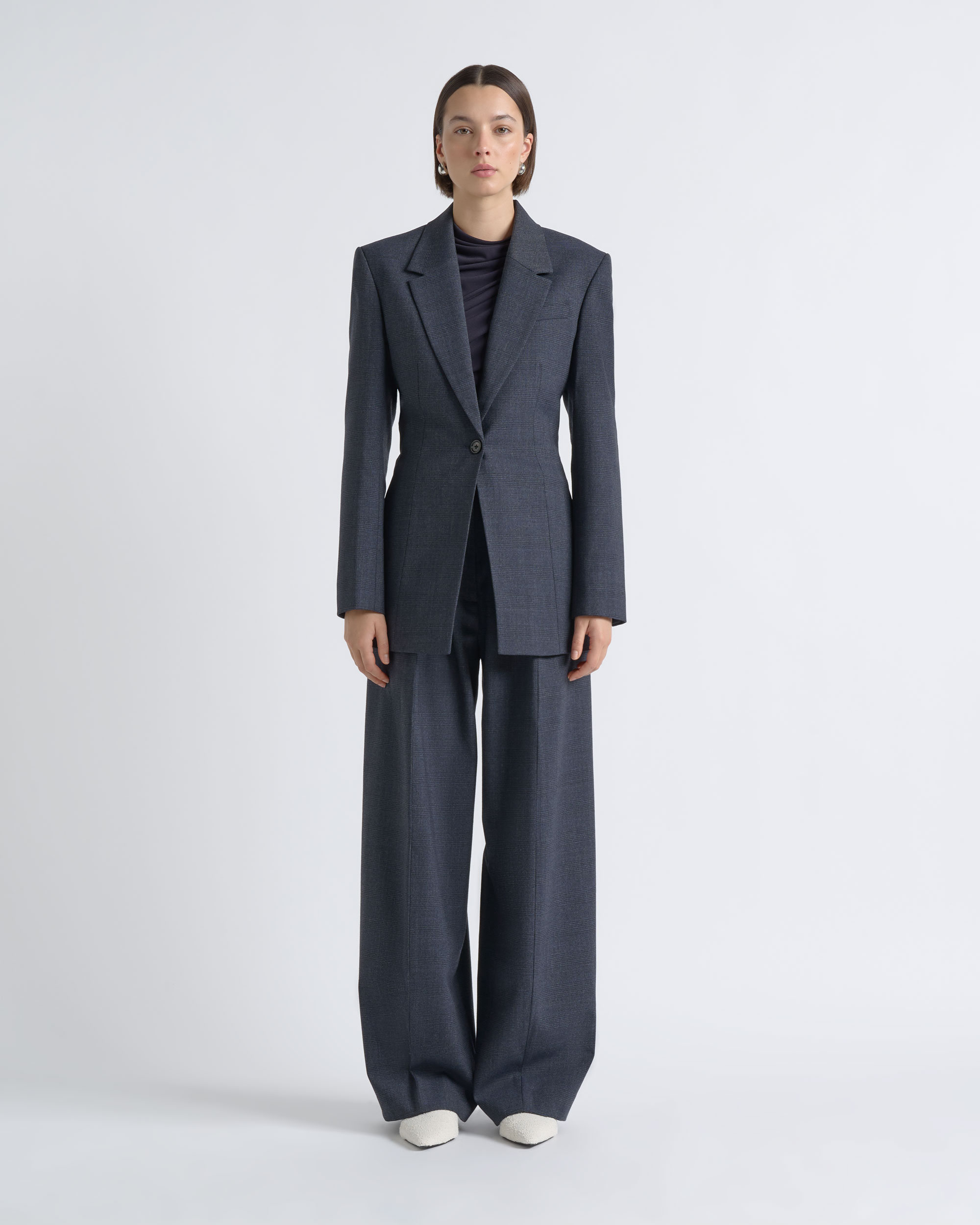 Front view of a model wearing a CUE charcoal suit.