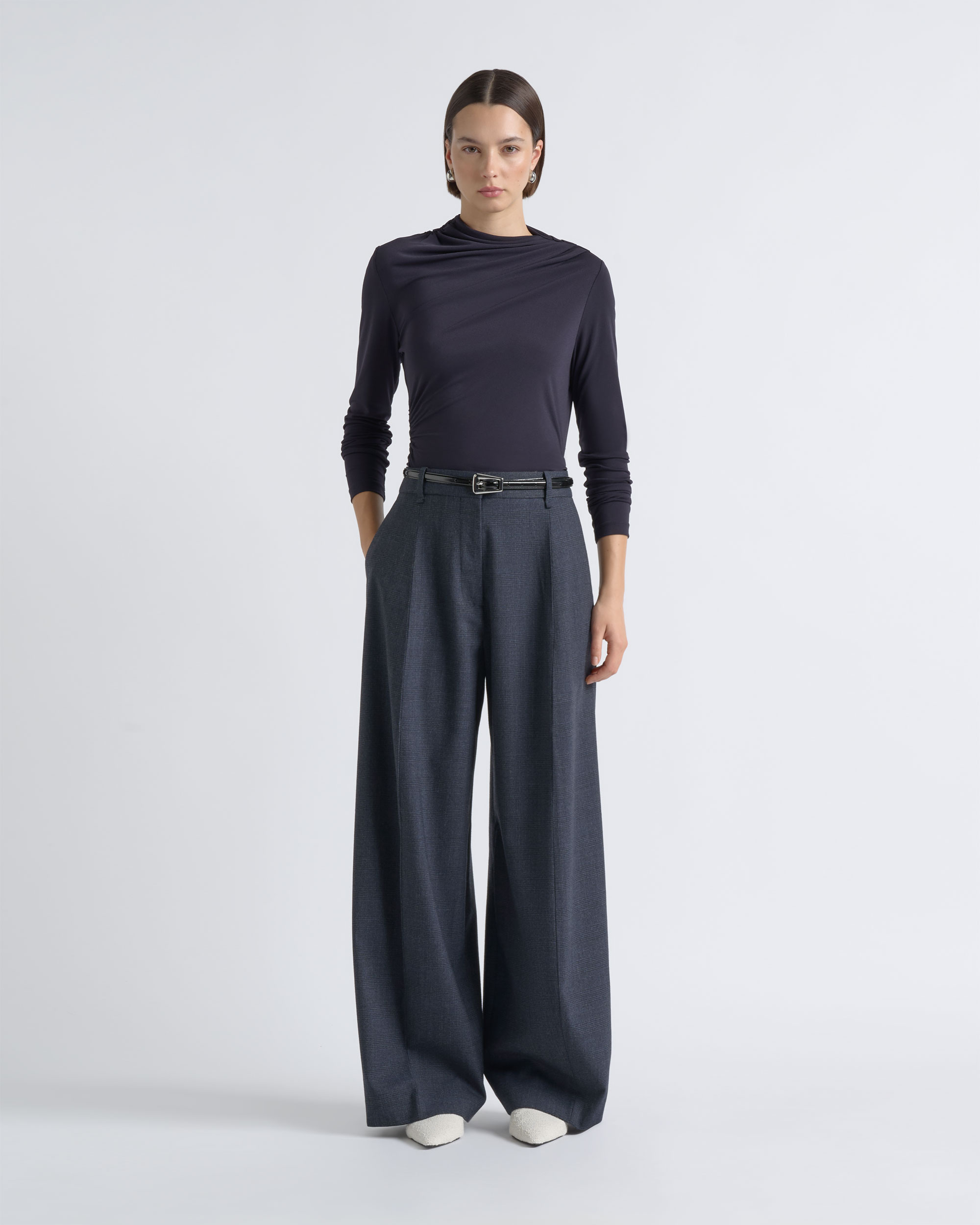 Front view of a model wearing a CUE charcoal top with wide-leg trousers.