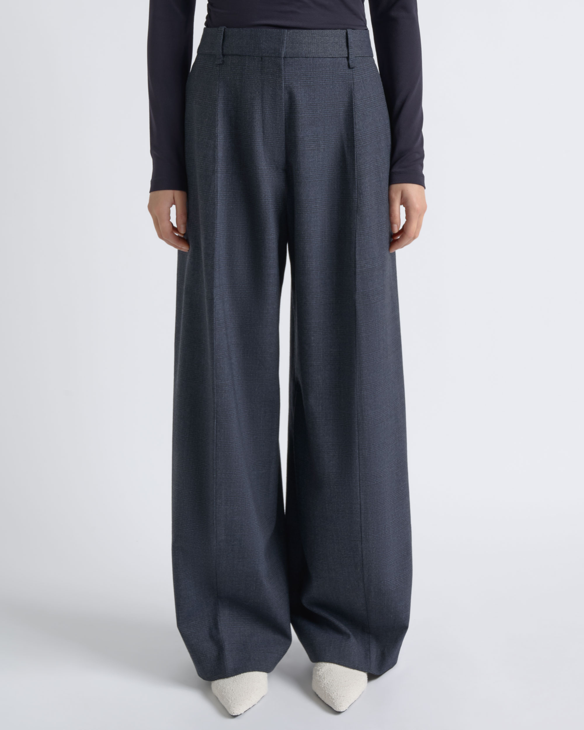 Detail view of CUE charcoal wide-leg trousers worn by a model.