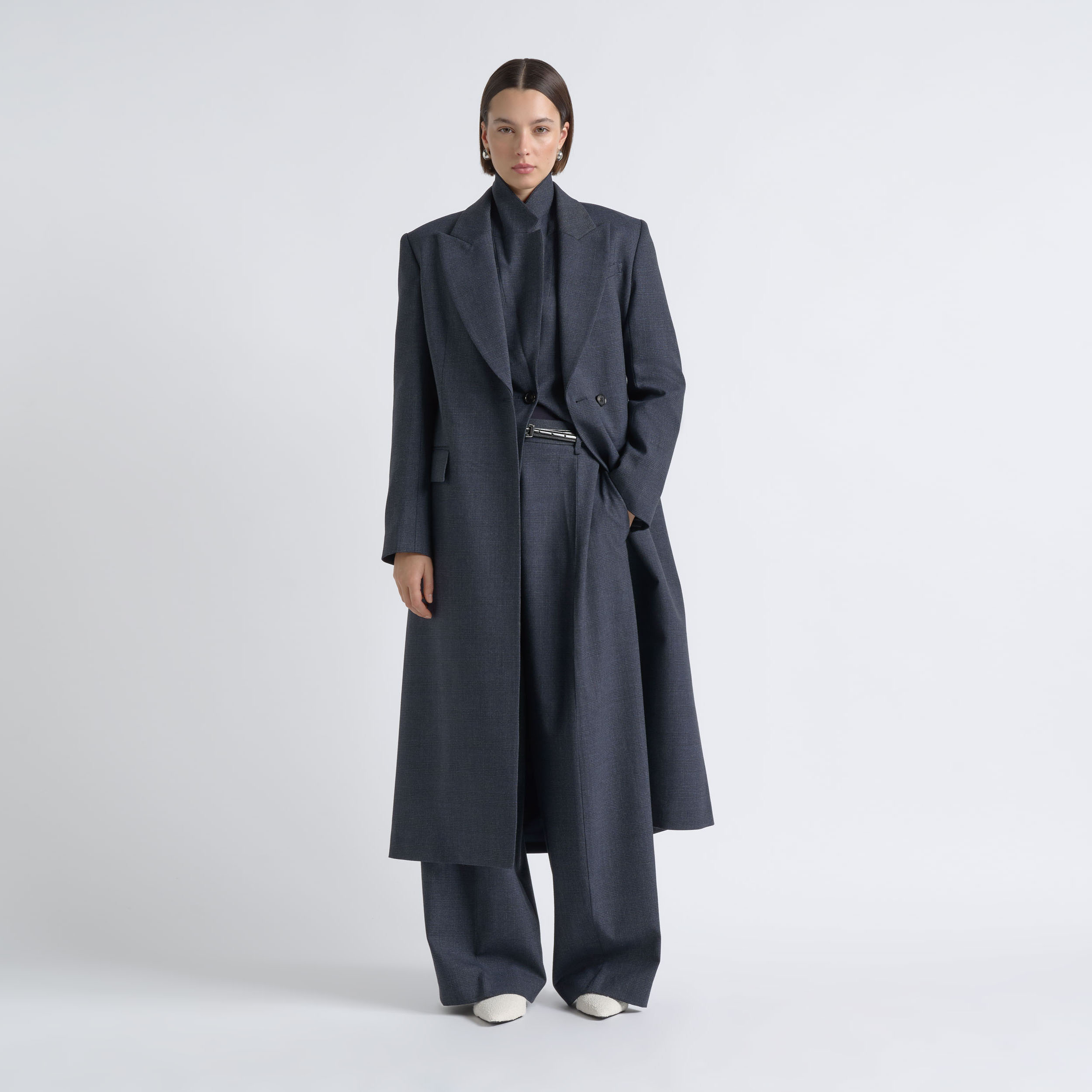 CUE fashion e-commerce photography by Shoot Studio Sydney featuring a female model in dark tailored outerwear.