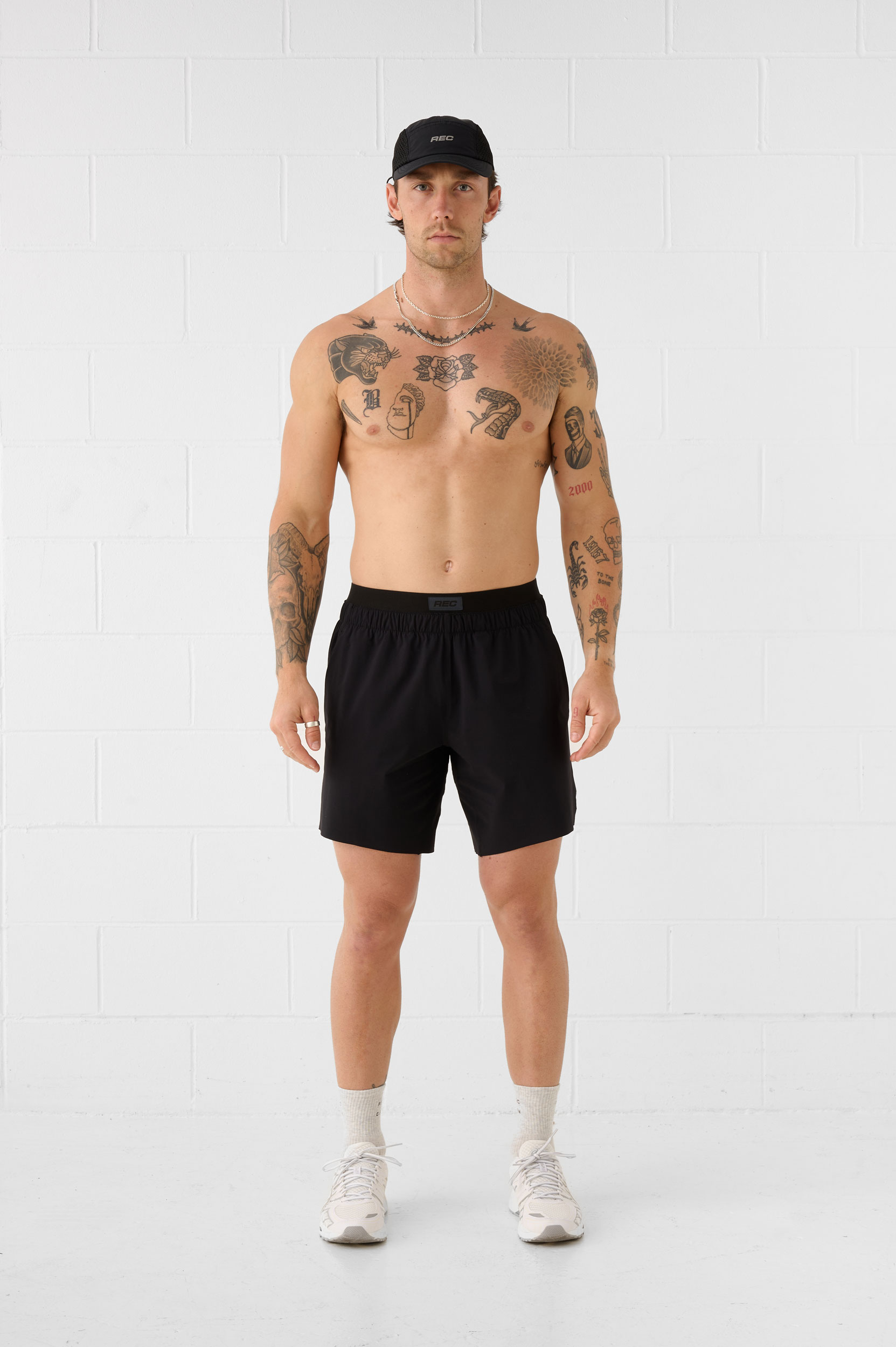 REC GEN men's black training shorts and cap, full-length front view