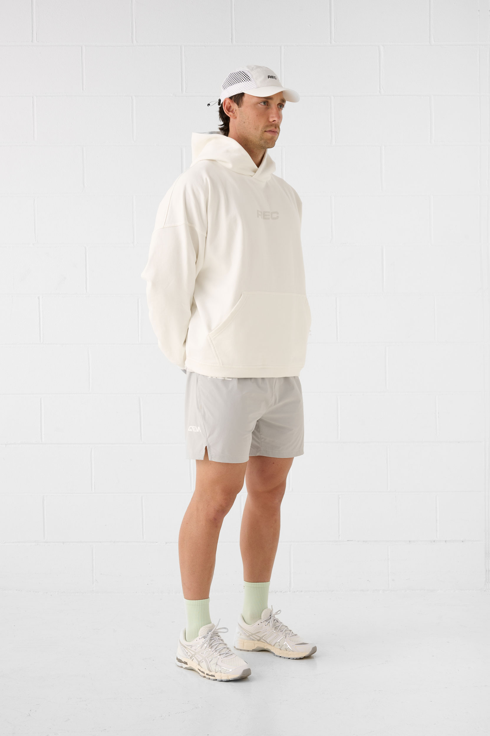 REC GEN men's cream hoodie and grey shorts, full-length side view