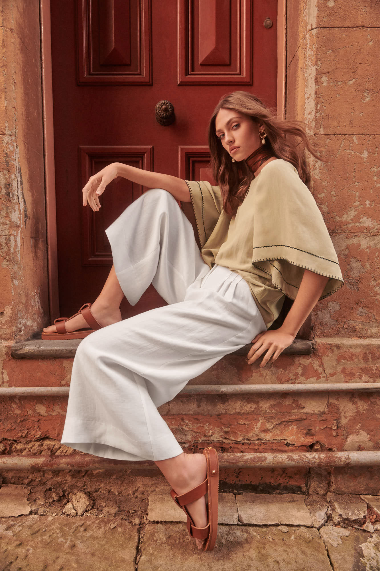 veronika-maine-fashion-campaign-beige-blouse-white-trousers-seated